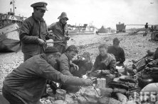 (details) A GMC truck in front of the wreckage of a LCVP. (details) A dead sailor on his boat. (details) Summary meals on the beach (details)