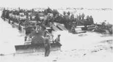 (details) A rhinoferry docks directly on the beach, held in place by track tractors